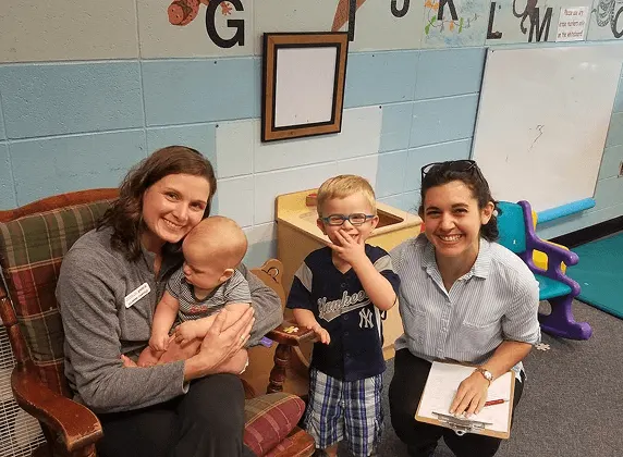 WCA Central Carolinas childcare staff with child in supervised play area Charlotte NC