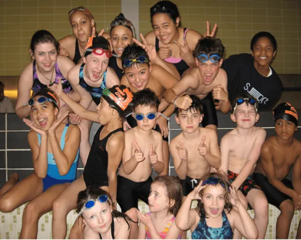 YWCA Orange Crush Swim Team making funny faces in a group image